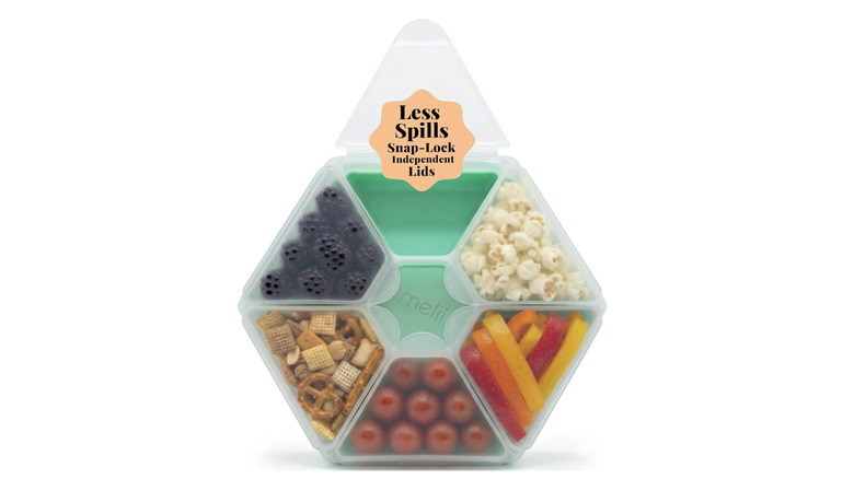 View of mint green melii Hexagone Snackle Box filled with blueberries, popcorn, bell peppers, and more on white background