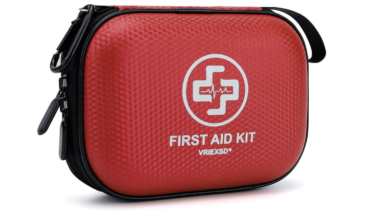 View of red structured mini first aid kit exterior on white background