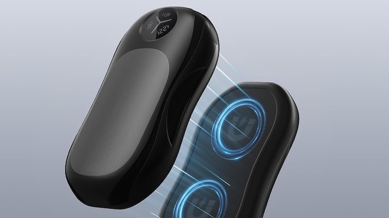 A woman holding WHATOOK hand warmers