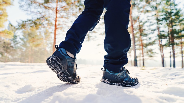 Person in boots walking in the snow