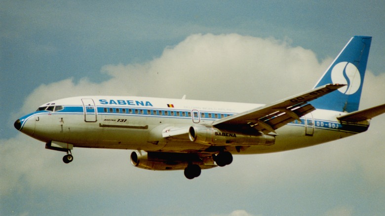Blue and white Sabena Boeing jet flying