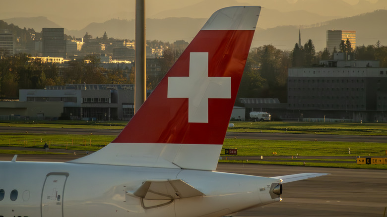Close-up of the tail of a Swiss plane on the tarmac