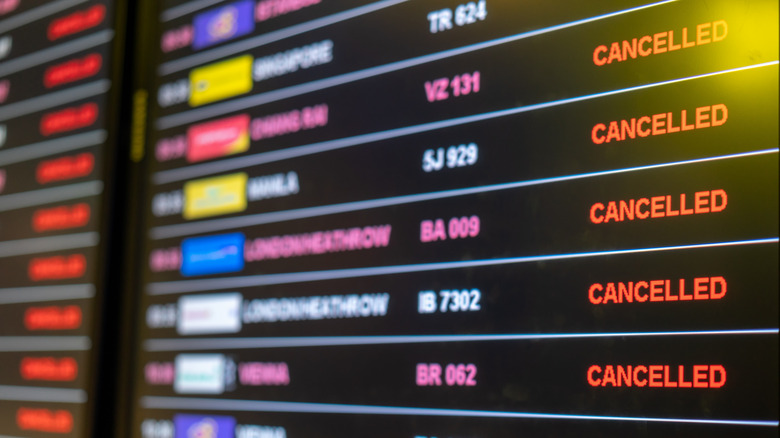 Airport departures board with cancelled flights