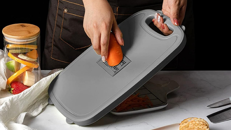 Grating a carrot on the Gintan 9-in-1 Collapsible Cutting Board