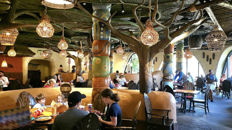 Interior view of African decor and large savanna-view windows at Sanaa restaurant at Disney's Animal Kingdom Lodge