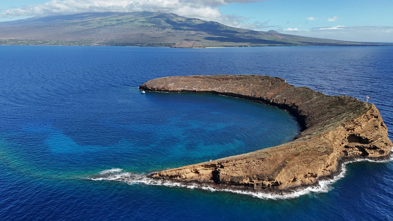 Molokini Crater with Maui in the background.