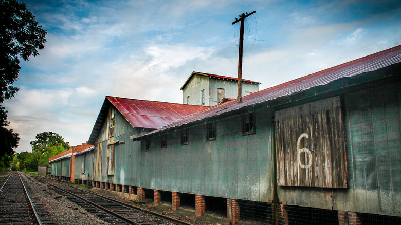 View of historic retired train station and railroad tracks in Havana, Florida