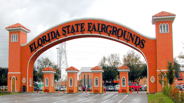 Bright orange gates entering the Florida State Fairgrounds in the Tampa area on a cloudy day