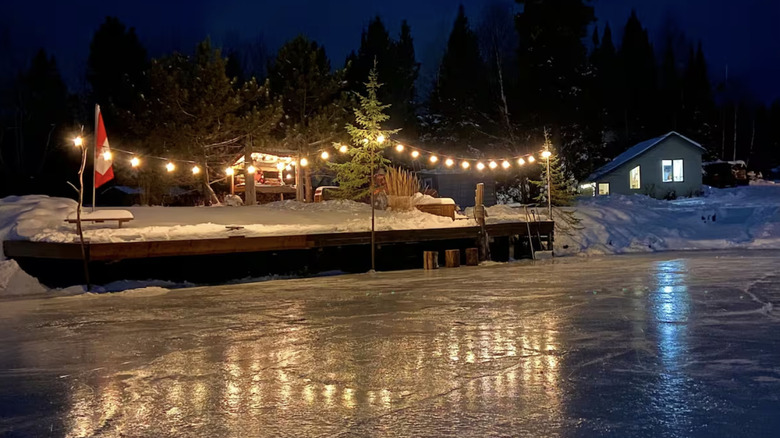 Cabin looking out onto frozen lake at night