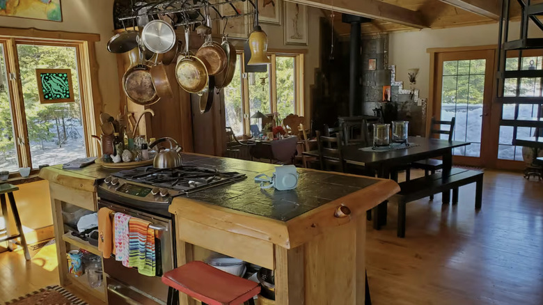 Warm kitchen with hanging pots over island