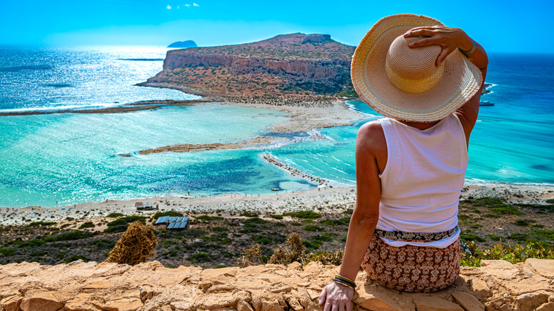 A woman looking at the Balos Lagoon from a viewpoint on Crete.