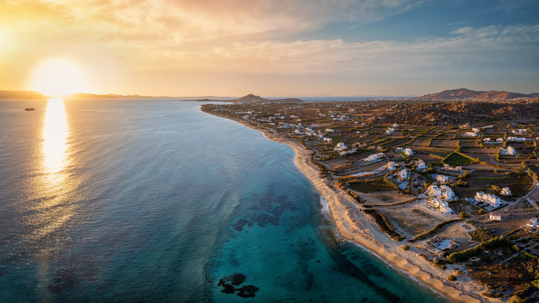 An aerial view of Plaka Beach at sunset.