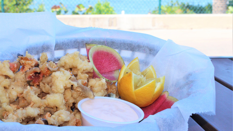 Fried conch with the ocean in the background