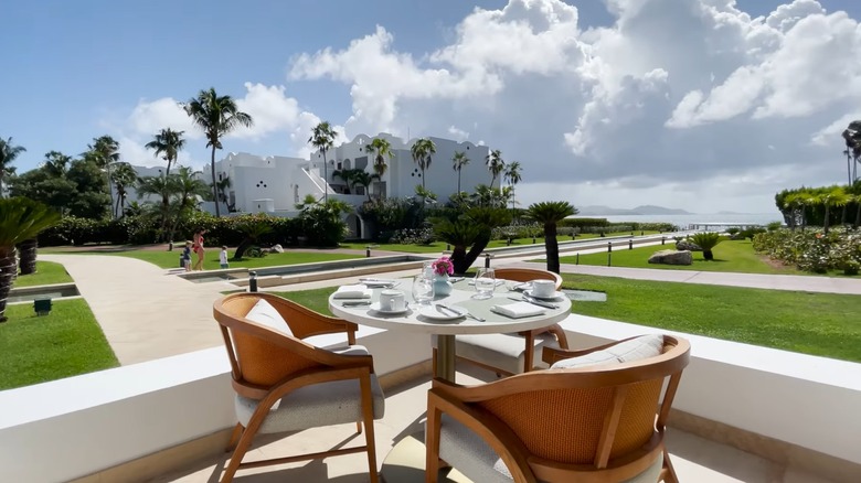 A table set for dining with views of the Aurora Anguilla grounds