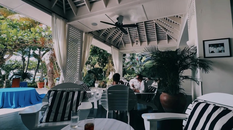 Guests enjoy high tea in an open-air resort seating area