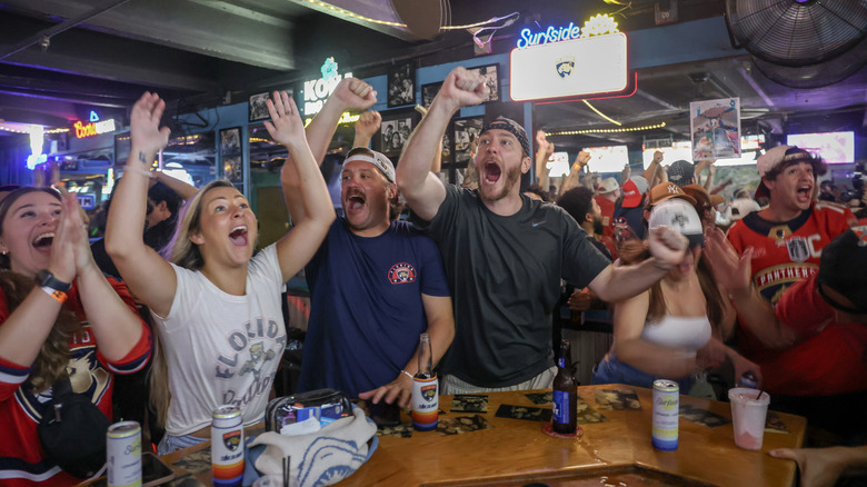 Group of hockey fans celebrating in a Florida dive bar