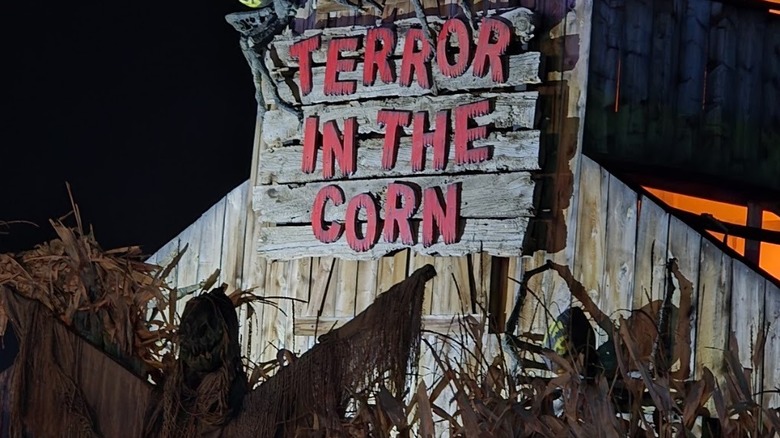 Red sign at the entrance for Terror in the Corn at night
