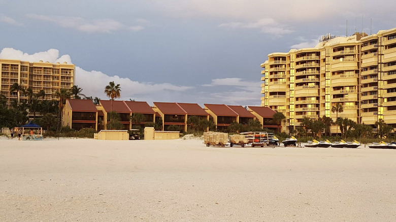 View of Club Regency by Hilton Grand Vacations from the beach, with towers and smaller condo-style accommodations visible on Marco Island, Florida
