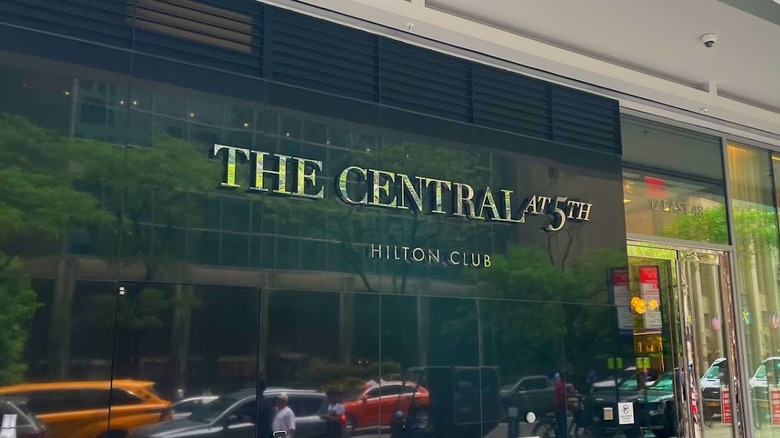 Exterior view of Hilton Club The Central at 5th with a Christmas tree visible through the front window