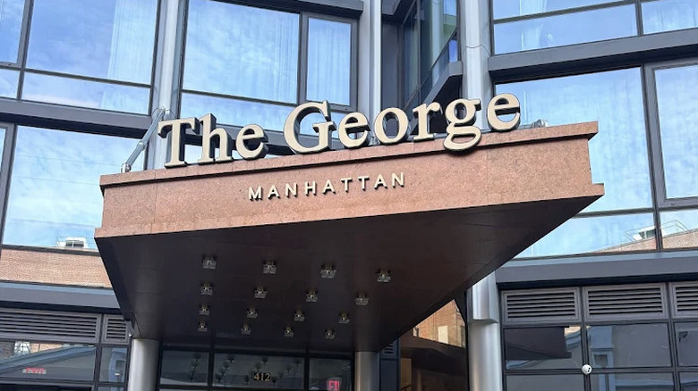 Exterior sign and bronze awning on The George Manhattan, a Tapesty Collection by Hilton hotel in Harlem