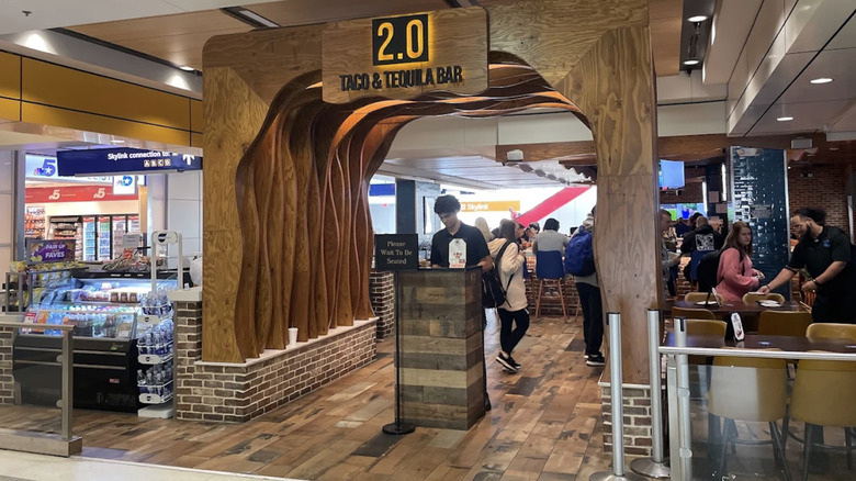 Host waiting to seat guests outside 2.0 Taco & Tequila Bar