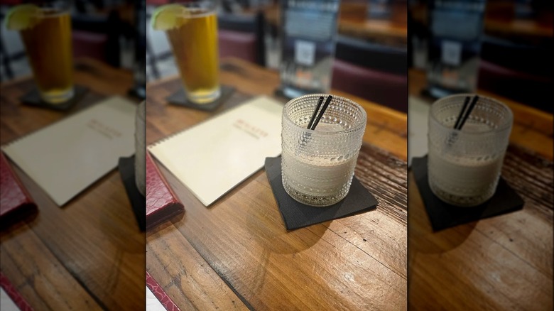 Drink on Wooden table next to menu