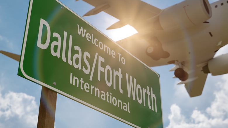 Plane flying over Dallas/Fort Worth sign