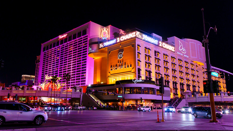 The Cromwell Hotel and Flamingo Casino brightly lit at night, showcasing vibrant signage and bustling street activity