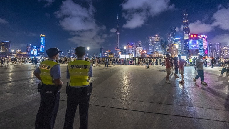 Police presence while tourists enjoy the Mid-Autumn Festival in Shanghai.