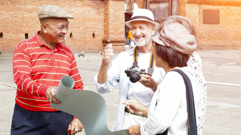 Foreign tourists interacting with a Chinese local.