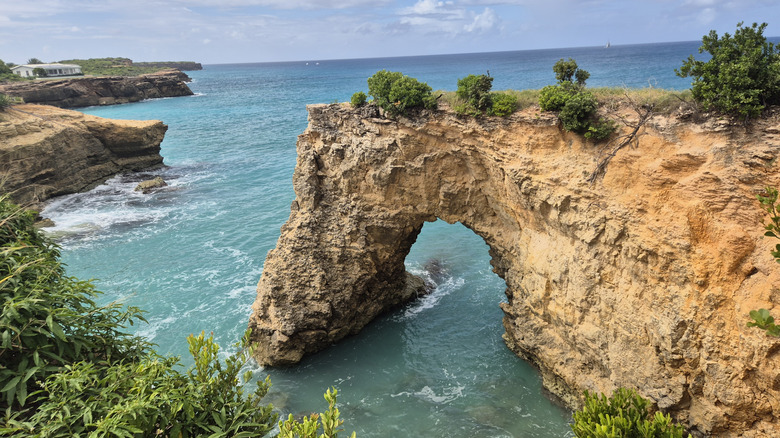 The breathtaking beauty of Anguilla Arch with the sea and blue sky in the distance.
