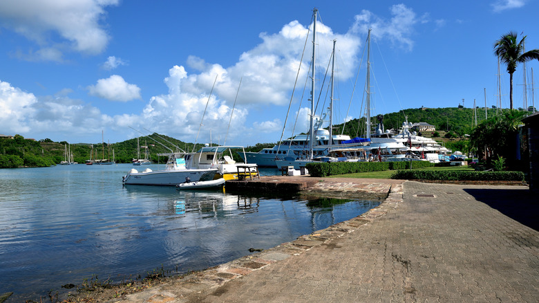 Jetty leading to Nelson's dockyard in Antigua with yachts moored up in the distance.