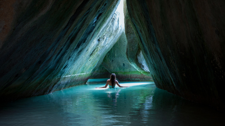 Woman standing in the water in one of the grottoes
