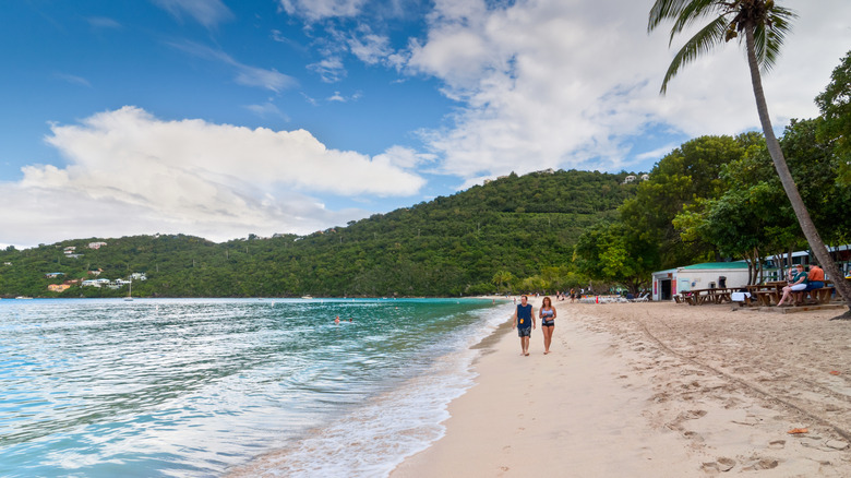 Couple walking down beach