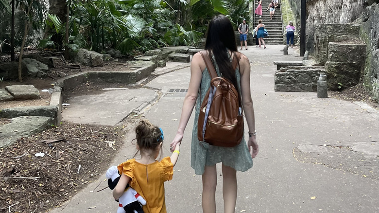 Dark-haired mother and daughter from the back