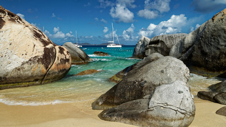 View of huge boulders with yachts in the backgrounds