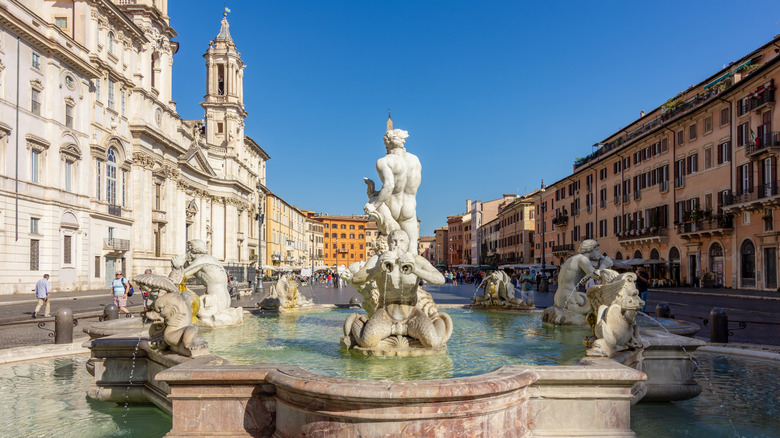 Piazza Navona with its central fountain and statues, surrounded by historic Renaissance buildings