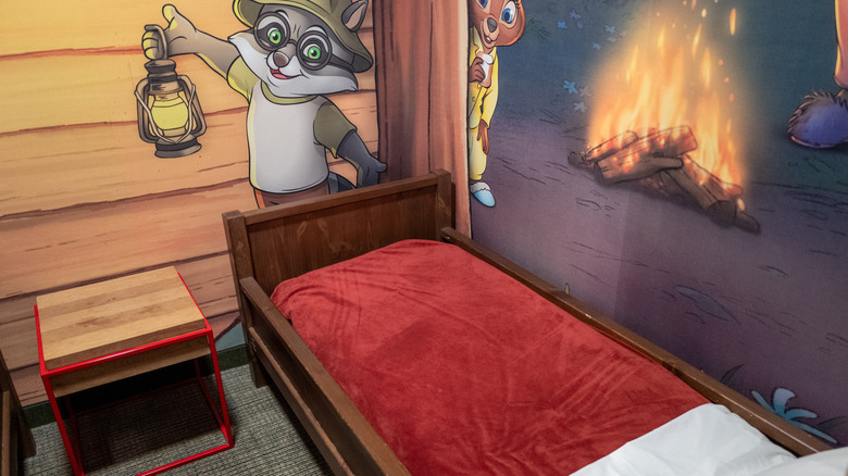 Themed kid's bedroom with cartoon animal mural and wooden bed at Great Wolf Lodge, Manteca, California.
