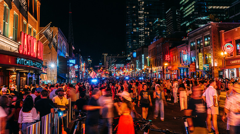 Vibrant neon lights and packed crowds on a busy night at the bars and honky-tonks on Nashville's Broadway