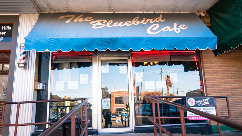Entrance to the legendary Bluebird Cafe, with sidewalk and iconic blue awning.