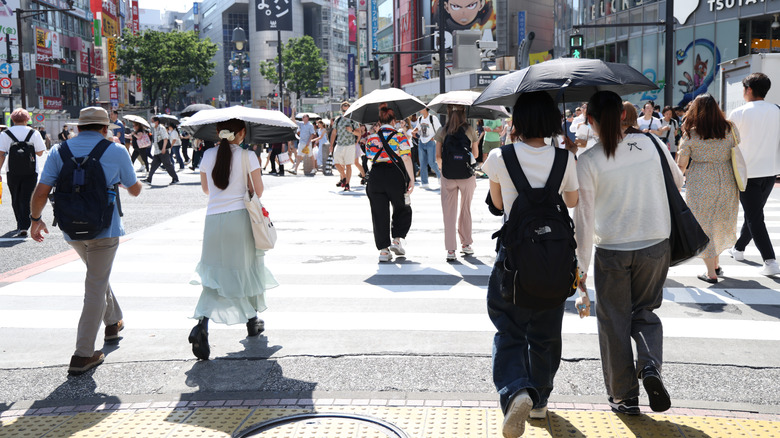 People brave intense heat with parasols on June 16, 2025 in Tokyo, Japan