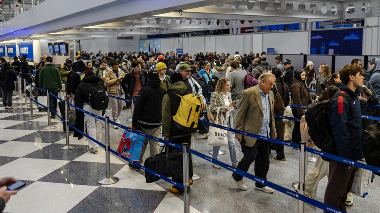 Travelers make their way through a security checkpoint in Terminal 1 at O'Hare International airport on November 30, 2025 in Chicago, Illinois