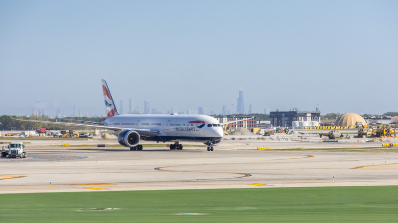 British Airways Boeing aircraft taxiing at O'Hare airport with Chicago skyline in background in September 2025
