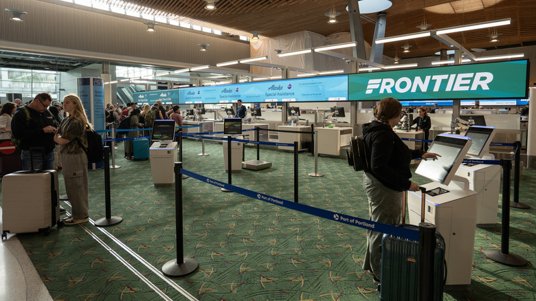 Check-in counters for Frontier Airlines and Alaska Airlines in the newly-renovated terminal building at Portland International Airport (PDX).