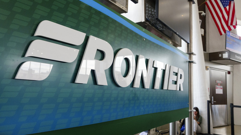 A Frontier Airlines logo is displayed at a gate at Ronald Reagan Washington National Airport on August 13, 2026 in Arlington, Virginia.