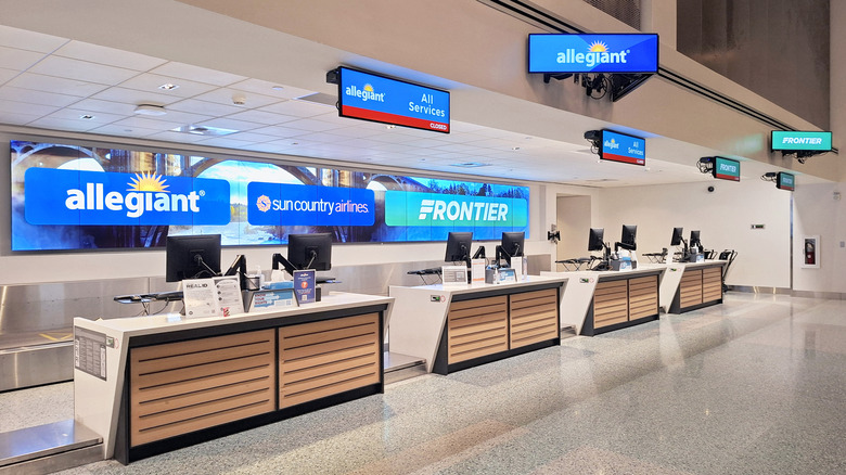 Spokane International Airport ticketing counter featuring Frontier Airlines, Allegiant Air, and Sun Country Airlines