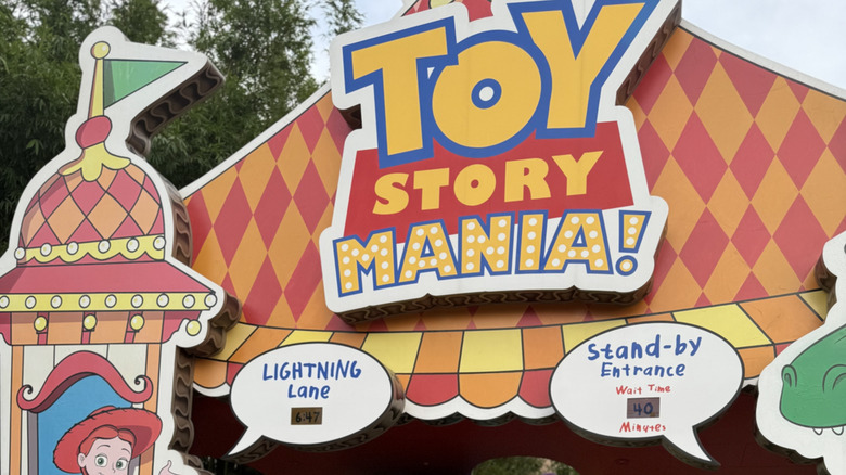 View of Toy Story Mania! ride marquee with Lightning Lane and Stand-by Entrance signs visible at Disney's Hollywood Studios
