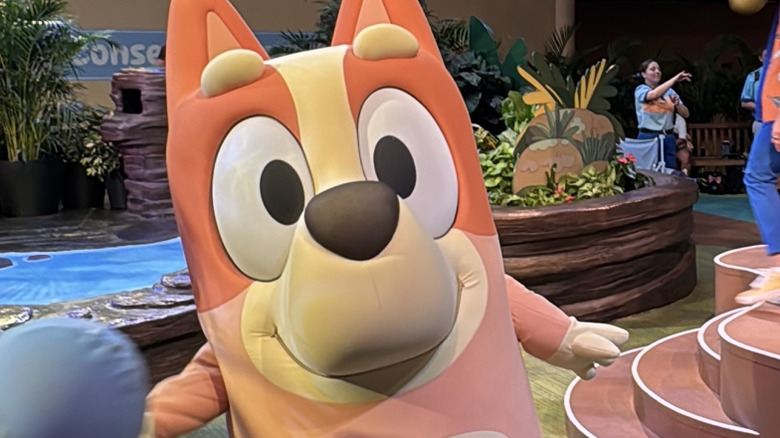 Close-up of Bingo playing with children at the Bluey's Wild World experience at Disney's Animal Kingdom theme park