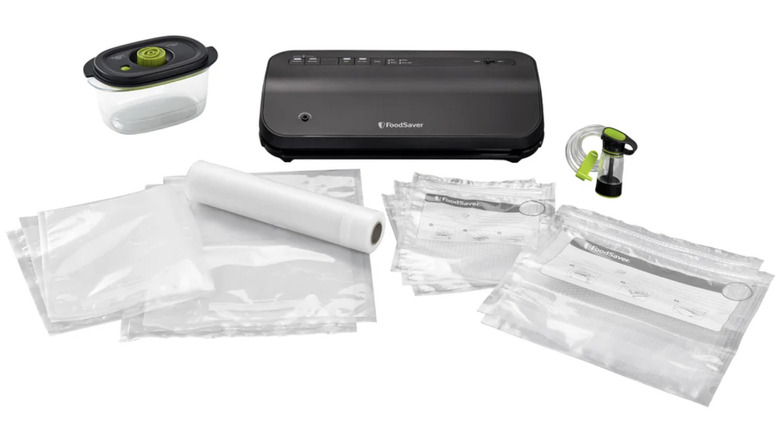View of FoodSaver vacuum sealer starter pack with unit, bags, and marinade container