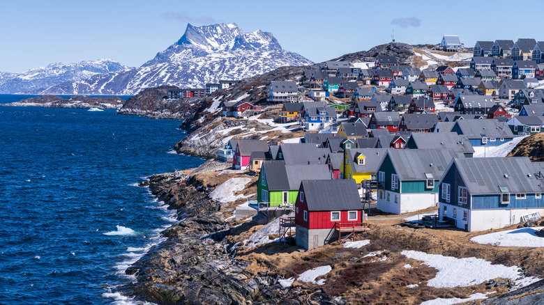Scenic view of colorful houses nestled along the coast of Nuuk, Greenland, with Sermitsiaq mountain in the background